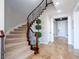 Elegant staircase with carpeted steps and wrought iron railing, illuminated by recessed lighting at 7125 Mountain Den Ave, Las Vegas, NV 89179