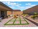 Inviting backyard features a brick patio with stylish outdoor furniture and well-manicured landscaping at 715 Drammatico Pl, Henderson, NV 89011
