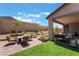 Inviting backyard with comfortable lounge area, fire pit, manicured grass, and ample space for relaxation at 715 Drammatico Pl, Henderson, NV 89011