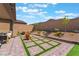 Spacious backyard featuring an outdoor seating area and decorative grass design at 715 Drammatico Pl, Henderson, NV 89011