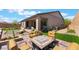 Relaxing backyard with cozy seating around a fire pit and manicured landscaping at 715 Drammatico Pl, Henderson, NV 89011