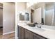 Stylish bathroom featuring double sinks with modern fixtures and vanity, complemented by neutral wall colors at 715 Drammatico Pl, Henderson, NV 89011