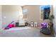 Bedroom with bright windows, neutral paint, and a comfortable chair is perfect for a room at 715 Drammatico Pl, Henderson, NV 89011