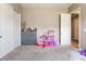 Neutral bedroom with closet, beige walls and carpeted floor, offering a bright, versatile space at 715 Drammatico Pl, Henderson, NV 89011