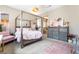 Bedroom featuring a four-poster bed, gray dresser and soft pink accents at 715 Drammatico Pl, Henderson, NV 89011