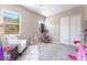 Bedroom featuring a large window, armchair, and carpet flooring at 715 Drammatico Pl, Henderson, NV 89011