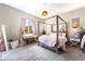 Charming bedroom with canopy bed, desk, and soft pink accents at 715 Drammatico Pl, Henderson, NV 89011