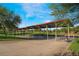 Shaded picnic area features multiple tables and seating under a covered structure, perfect for gatherings at 715 Drammatico Pl, Henderson, NV 89011