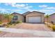 Charming single-story home with a well-manicured yard and brick-paved driveway at 715 Drammatico Pl, Henderson, NV 89011