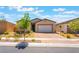 Charming single-story home featuring a well-manicured front yard and brick paver driveway at 715 Drammatico Pl, Henderson, NV 89011