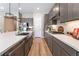 Spacious kitchen with stainless steel appliances, gray cabinets, island, and modern pendant lighting at 715 Drammatico Pl, Henderson, NV 89011