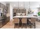 Bright kitchen with gray cabinets, stainless steel appliances, island, and modern pendant lighting at 715 Drammatico Pl, Henderson, NV 89011