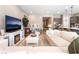 Bright and airy living room with a fireplace, hardwood floors, and a spacious layout at 715 Drammatico Pl, Henderson, NV 89011