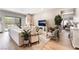 Bright living room with a large white sofa and sliding glass doors to the backyard at 715 Drammatico Pl, Henderson, NV 89011