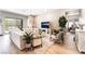 Spacious living room with hardwood floors, fireplace, and sliding glass door to the backyard at 715 Drammatico Pl, Henderson, NV 89011