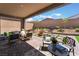 Charming outdoor patio with stylish seating, lush plants, and a relaxing ambiance for entertaining at 715 Drammatico Pl, Henderson, NV 89011
