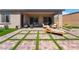 Inviting patio with outdoor seating and well-maintained artificial grass at 715 Drammatico Pl, Henderson, NV 89011