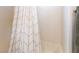 Close-up of a shower featuring geometric patterned shower curtain at 715 Drammatico Pl, Henderson, NV 89011