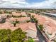 Nice aerial view of a neighborhood filled with warm terracotta roofs and mature trees at 7450 S Eastern Ave # 2073, Las Vegas, NV 89123