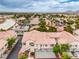 A pleasant aerial perspective showcases a neighborhood with warm terracotta roofs and vibrant trees at 7450 S Eastern Ave # 2073, Las Vegas, NV 89123