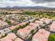 Gorgeous aerial view of the neighborhood, showcasing the beautiful terracotta roofs and lush trees at 7450 S Eastern Ave # 2073, Las Vegas, NV 89123