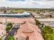 Beautiful aerial view of a neighborhood with warm terracotta roofs and lush trees at 7450 S Eastern Ave # 2073, Las Vegas, NV 89123