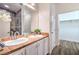 Bathroom with a double sink vanity, framed mirrors, and a walk-in closet at 7450 S Eastern Ave # 2073, Las Vegas, NV 89123