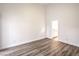 Minimalist bedroom with wood floors leading to an en suite bathroom at 7450 S Eastern Ave # 2073, Las Vegas, NV 89123