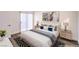 Nicely staged bedroom with hardwood floors, neutral colors and balcony access at 7450 S Eastern Ave # 2073, Las Vegas, NV 89123