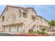 Exterior view of townhome with garages, private staircases, and manicured landscaping at 7450 S Eastern Ave # 2073, Las Vegas, NV 89123