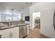 Modern kitchen with stainless steel appliances, granite counters, and an adjacent laundry area at 7450 S Eastern Ave # 2073, Las Vegas, NV 89123