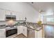 Bright kitchen features white cabinets, granite countertops, stainless steel appliances, and an open layout at 7450 S Eastern Ave # 2073, Las Vegas, NV 89123
