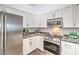 Bright kitchen featuring granite counters, stainless appliances and white cabinets at 7450 S Eastern Ave # 2073, Las Vegas, NV 89123