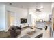 Staged living room featuring an open floor plan that combines the living, kitchen, and dining areas at 7450 S Eastern Ave # 2073, Las Vegas, NV 89123