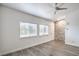A spacious room with natural light, stone accent wall and wood-look flooring, creating a modern and welcoming atmosphere at 7450 S Eastern Ave # 2073, Las Vegas, NV 89123