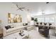 A bright, staged living room with modern furnishings and a view into the dining area at 7450 S Eastern Ave # 2073, Las Vegas, NV 89123