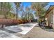 Spacious backyard with a concrete pad, perfect for parking or outdoor activities, enclosed by a brick wall at 7504 Via Sistina St, Las Vegas, NV 89131