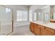 Bathroom with separate shower, soaking tub, tile floors, and light wood cabinets at 7504 Via Sistina St, Las Vegas, NV 89131