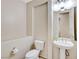 A simple bathroom with a toilet and small pedestal sink at 7504 Via Sistina St, Las Vegas, NV 89131