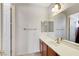 Bathroom featuring a vanity with light wood cabinets and a large mirror at 7504 Via Sistina St, Las Vegas, NV 89131