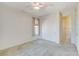 Bright bedroom with neutral carpet, closet, and decorative ceiling fan at 7504 Via Sistina St, Las Vegas, NV 89131