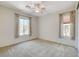 Bedroom with carpet flooring, two windows, and neutral wall color at 7504 Via Sistina St, Las Vegas, NV 89131