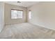 Spacious bedroom with neutral carpet and paint, and natural light from a large window at 7504 Via Sistina St, Las Vegas, NV 89131