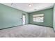 Bedroom with neutral walls, neutral carpet, a window and a glass door leading to outside at 7504 Via Sistina St, Las Vegas, NV 89131