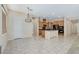 Well-lit kitchen and dining area with pendant lighting, tile floors, and wood cabinetry at 7504 Via Sistina St, Las Vegas, NV 89131
