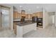Modern kitchen with granite countertops, stainless steel appliances, and a center island at 7504 Via Sistina St, Las Vegas, NV 89131