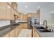 Modern kitchen features tile floors, wood cabinets, granite countertops, and stainless appliances at 7504 Via Sistina St, Las Vegas, NV 89131