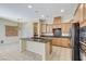 Bright kitchen with stainless steel appliances, granite countertops, and a functional island at 7504 Via Sistina St, Las Vegas, NV 89131