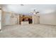 Open-concept living room features neutral tones, an island kitchen, and access to the front door at 7504 Via Sistina St, Las Vegas, NV 89131