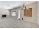 Bright living room showcases large windows with blinds, a fireplace, and a tiled floor at 7504 Via Sistina St, Las Vegas, NV 89131